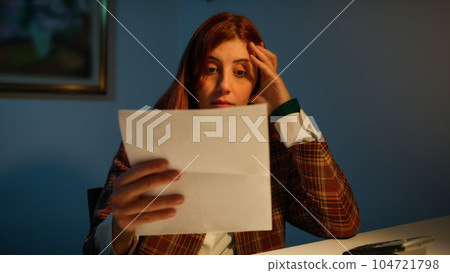 Girl reads a worrying letter 104721798