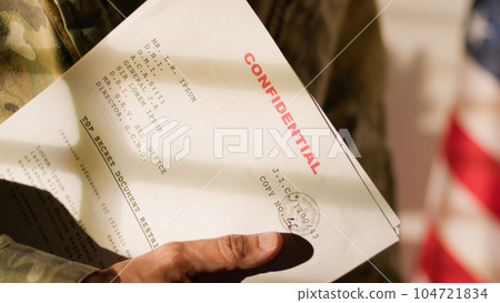 American military office with military man holding documents American military office with military man holding documents 104721834