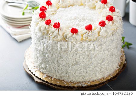 Coconut cake with maraschino cherries 104722180