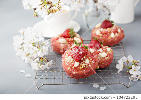 Strawberry shortcake donuts on a cooling rack 104722195