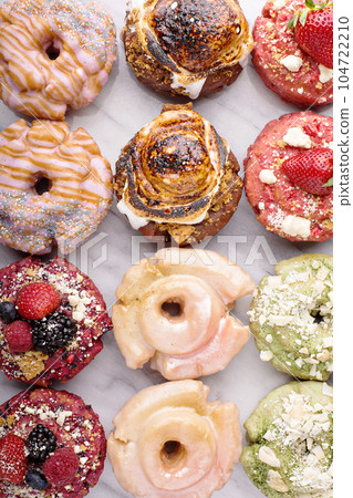 Variety of donuts on a marble surface 104722210