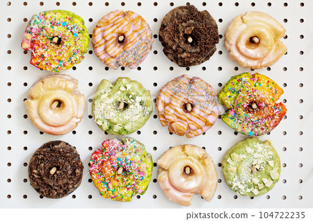 Variety of donuts on a peg board 104722235