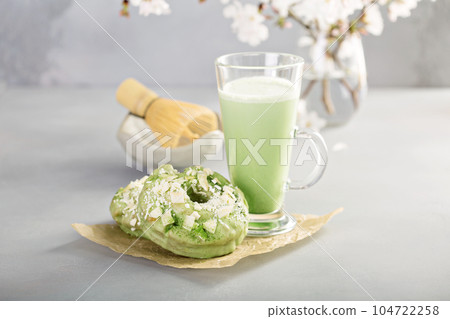 Matcha and white chocolate donuts with tea Matcha and white chocolate donuts with tea 104722258