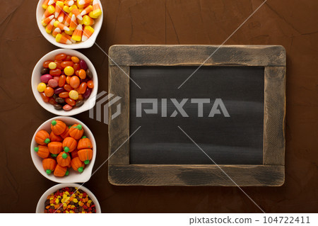 Halloween candy in little white bowls Halloween candy in little white bowls 104722411