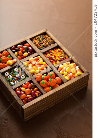 Halloween candy in a wooden box Halloween candy in a wooden box 104722419