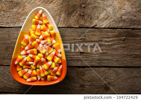 Candy corn in a bowl Halloween background Candy corn in a bowl Halloween background 104722429