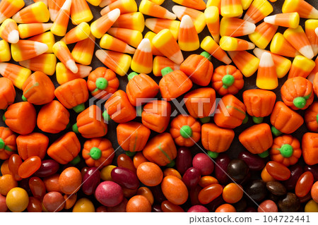 Candy corn and pumpkin Halloween background 104722441