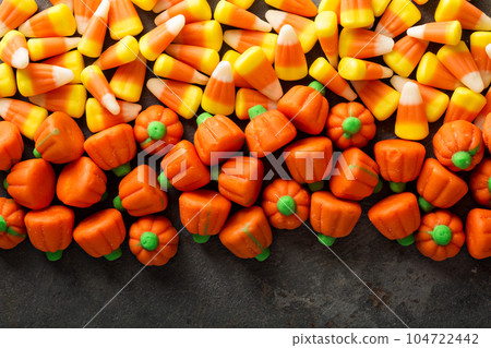 Candy corn and pumpkin Halloween background 104722442