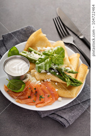 Savory crepes with salmon, sour cream and asparagus Savory crepes with salmon, sour cream and asparagus 104722464