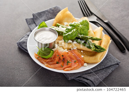 Savory crepes with salmon, sour cream and asparagus 104722465