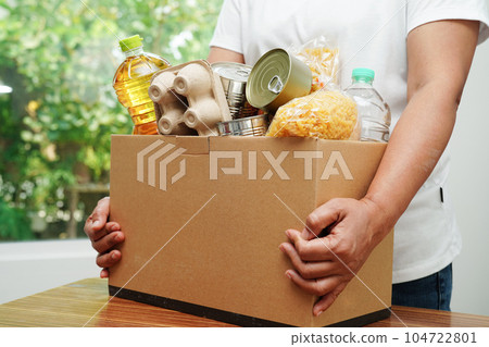 Foodstuffs in donation box for volunteer to help people. Foodstuffs in donation box for volunteer to help people. 104722801