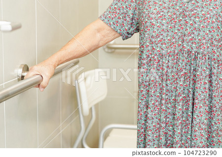 Asian elderly old woman patient use toilet support rail in bathroom, handrail safety grab bar, security in nursing hospital. Asian elderly old woman patient use toilet support rail in bathroom, handrail safety grab bar, security in nursing hospital. 104723290