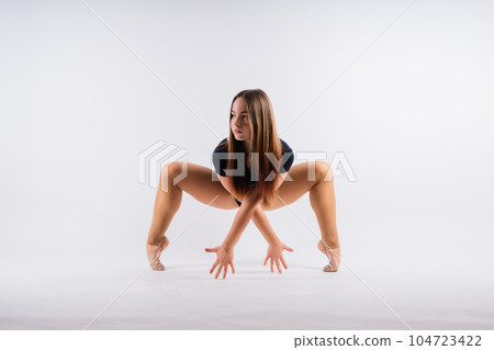 Fashion girl ballet dancer. Sport gymnastics studio shot on white and black background Fashion girl ballet dancer. Sport gymnastics studio shot on white and black background 104723422