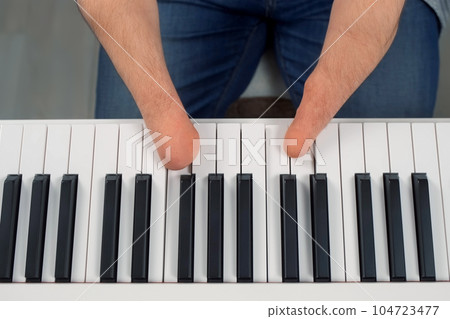 Man with physical disability amputated two hands musician is playing the piano. Man with physical disability amputated two hands musician is playing the piano. 104723477