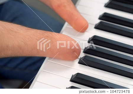 Man with physical disability amputated two hands musician is playing the piano. Man with physical disability amputated two hands musician is playing the piano. 104723478