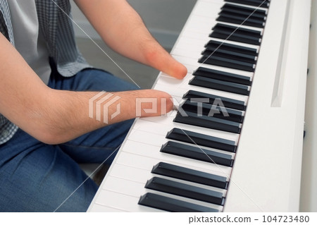 Man with physical disability amputated two hands musician is playing the piano. Man with physical disability amputated two hands musician is playing the piano. 104723480