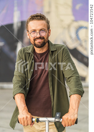 Man photographed outdoors, basking in natural sunlight. With confident and stylish appearance, he exudes relaxed and charismatic vibe. outdoor setting adds touch of authenticity and freshness to image Man photographed outdoors, basking in natural sunlight. With confident and stylish appearance, he exudes relaxed and charismatic vibe. outdoor setting adds touch of authenticity and freshness to image 104723542