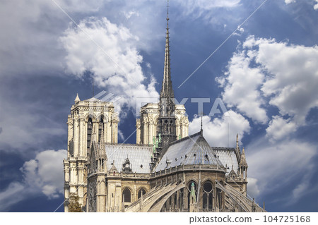 Notre Dame de Paris (against the background of sky with clouds), also known as Notre Dame Cathedral or simply Notre Dame, is a Gothic, Roman Catholic cathedral of Paris, France Notre Dame de Paris (against the background of sky with clouds), also known as Notre Dame Cathedral or simply Notre Dame, is a Gothic, Roman Catholic cathedral of Paris, France 104725168