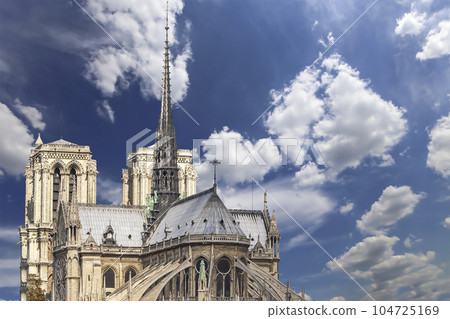 Notre Dame de Paris (against the background of sky with clouds), also known as Notre Dame Cathedral or simply Notre Dame, is a Gothic, Roman Catholic cathedral of Paris, France 104725169