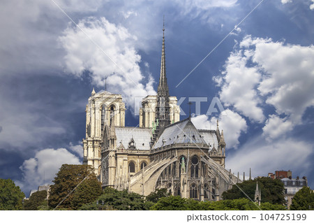 Notre Dame de Paris (against the background of sky with clouds), also known as Notre Dame Cathedral or simply Notre Dame, is a Gothic, Roman Catholic cathedral of Paris, France Notre Dame de Paris (against the background of sky with clouds), also known as Notre Dame Cathedral or simply Notre Dame, is a Gothic, Roman Catholic cathedral of Paris, France 104725199