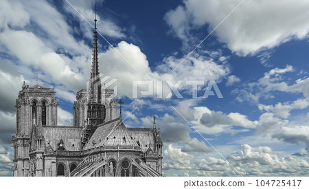 Notre Dame de Paris (against the background of sky with clouds), also known as Notre Dame Cathedral or simply Notre Dame, is a Gothic, Roman Catholic cathedral of Paris, France 104725417