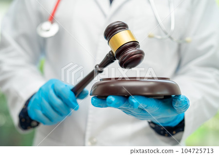 Doctor holding judge gavel, forensic medicine, medical law and crime justice concept. 104725713