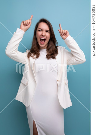 smiling young brunette with long hair lady in white dress has a cool idea and wants to tell about it smiling young brunette with long hair lady in white dress has a cool idea and wants to tell about it 104726052
