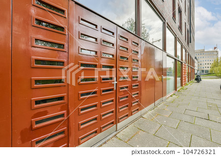 a red door on the side of a building that has been painted to look like an old fire hydrae a red door on the side of a building that has been painted to look like an old fire hydrae 104726321