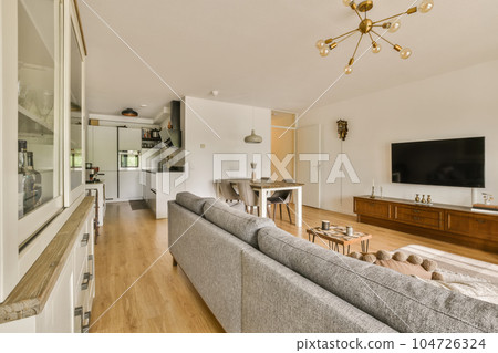 a living room with couches and a flat screen tv on the wall in the center of the room is an entertainment area a living room with couches and a flat screen tv on the wall in the center of the room is an entertainment area 104726324