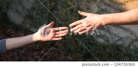 Man reaching out to help his friend Man reaching out to help his friend 104726360