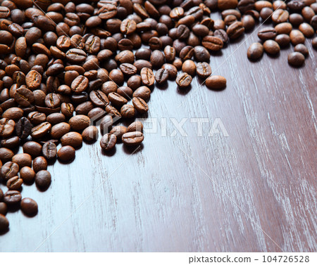 Coffee grains on a wooden table Coffee grains on a wooden table 104726528