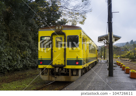 A train car parked at a station platform of a local line 104726611