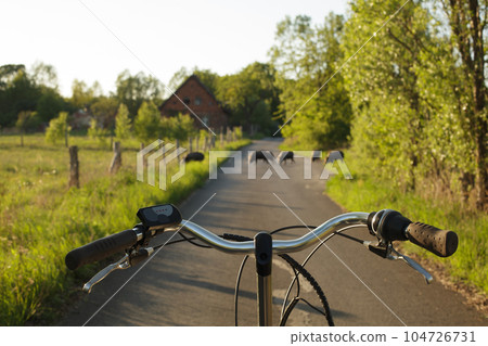 Wild animals and a cyclist on the road, pay attention to safety. 104726731