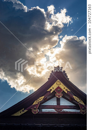 Early summer at Yasaka Shrine, rainy season blue sky and Rembrandt rays on gables of national treasure main hall 104727163