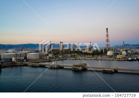 storage tank farm at night, Tank farm storage chemical petroleum petrochemical refinery product at oil terminal, Business commercial trade fuel and energy transport by tanker vessel. 104727719