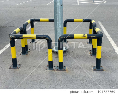 black and yellow safety tape outdoors in the street, restricted area 104727769