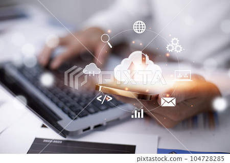 Businessman hand holding smartphone and laptop with cloud computing diagram show on hand. Cloud technology. Data storage. Networking and internet service concept, Cloud sharing download and upload 104728285