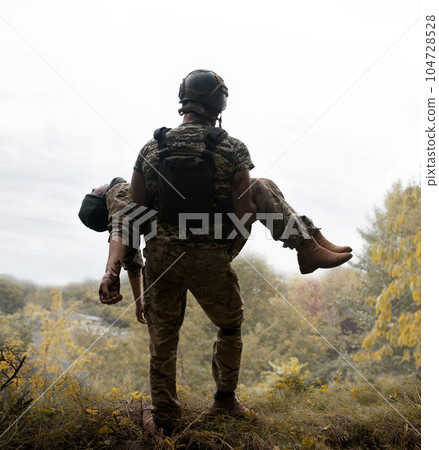 The commander carries a wounded soldier 104728528