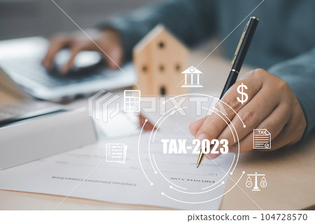 US IRS 1040 form or  US Individual income tax Concept,accountant holding pen working on calculator business with data accounting documents and a laptop, pay tax in 2023 years,new year 2023 tax concept 104728570