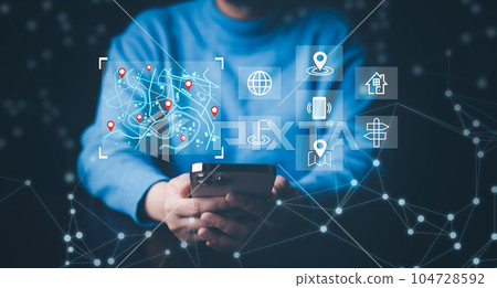 Man using Smartphone with virtual world and model map with location point, GPS app, icon Travel maps and find places in the online system, all screen graphics are generated, Searching for travel. Man using Smartphone with virtual world and model map with location point, GPS app, icon Travel maps and find places in the online system, all screen graphics are generated, Searching for travel. 104728592