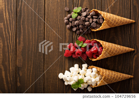 Ingrediens for smore's dessert in a waffle cone Ingrediens for smore's dessert in a waffle cone 104729656