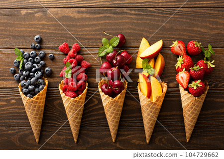 Fresh fruit and berries in waffle cones Fresh fruit and berries in waffle cones 104729662