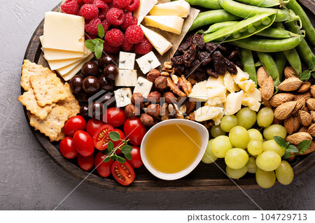 Cheese and vegetables board 104729713