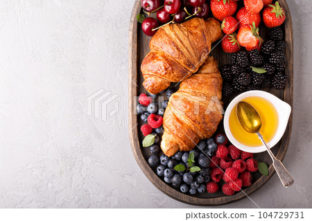 Healthy breakfast with freshly baked croissants and berries 104729731