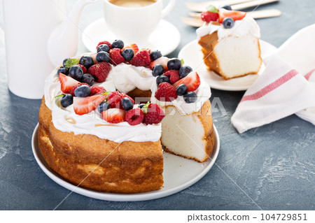 Angel food cake with whipped cream and berries Angel food cake with whipped cream and berries 104729851