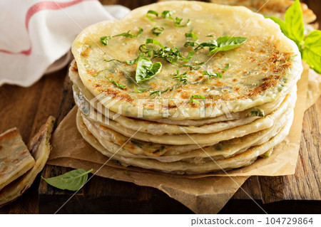 Fried green onion pancakes 104729864