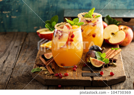Fall sangria cocktail with apple, figs and orange Fall sangria cocktail with apple, figs and orange 104730369