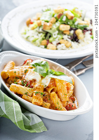 Pasta rigatoni with tomato sauce 104730391