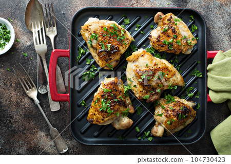 Grilled or roasted chicken thighs 104730423