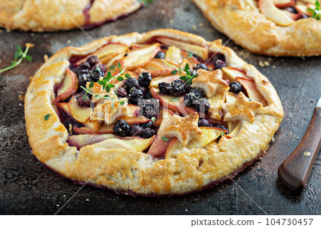 Summer galette with peaches and blueberries 104730457